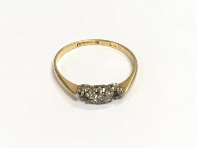 An 18ct gold diamond ring, two stones missing, approx 1.59g and approx size N.