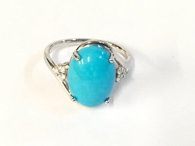 An 18ct white gold ring set with oval Turquoise. Size N 1/2