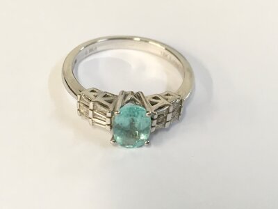 An 18ct white gold ring set with Paraiba Tourmaline and diamonds. Size N 1/2 and 3.40g