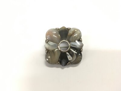 A white metal and stone brooch with two pendants.