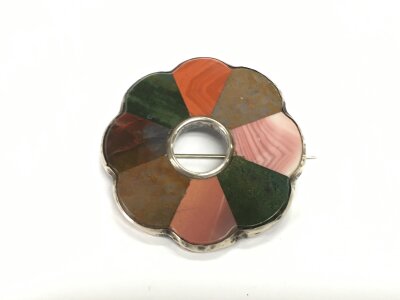 A multi stone and white metal circular brooch, approx diameter 5.5cm.