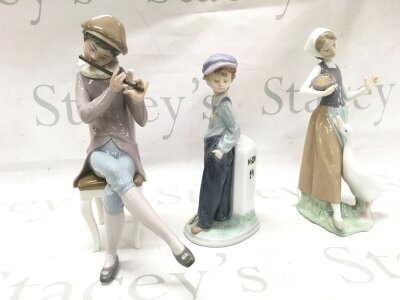 Three Lladro figures including Boy playing flute, The wanderer , girl with goose. 22 and 25cm tall NO RESERVE