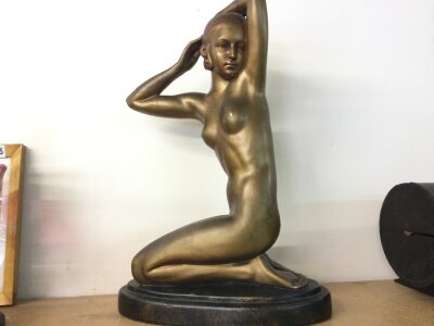 An Art Deco bronze effect plaster figure of a nude lady