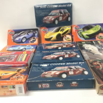 A collection of 12 boxed model car kits by Airfix..Revell and Marks and Spencer&rsquo;s.