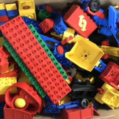 A box of assorted Duplo. Postage C