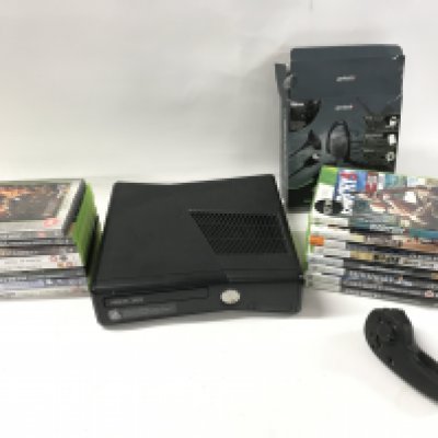 An Xbox 360 console with a number of games and other accessories. No Reserve
