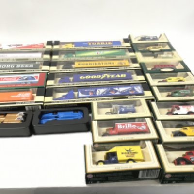 A collection of 25 boxed model vehicles including truck and trailers..vans and cars. Manufacturers include Lledo.