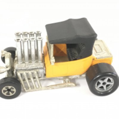 A Matchbox Superkings pre production model T hotrod in orange livery a black roof and no decals.