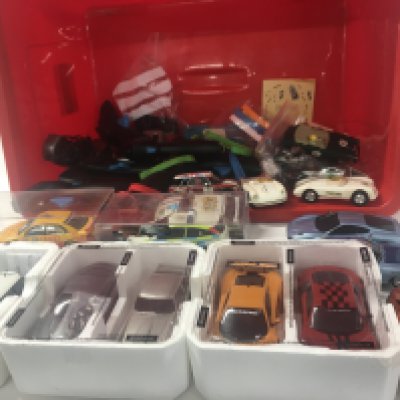 A box containing in excess of 12 Scalextric cars plus accessories and approximately 10 hand controllers.