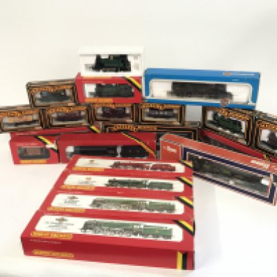 A box containing a collection of various trains and coaches. To include Hornby, Lima amount others. No reserve.