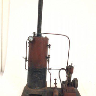 A bespoke static steam engine mounted on a wooden plinth.