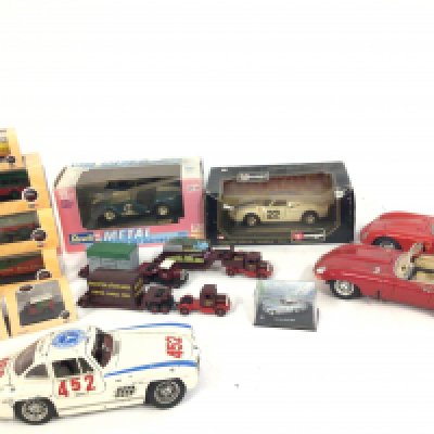 A collection of 15 model vehicles by burago..Oxford..Lledo etc. some boxed and unused others loose an Playworn. No reserve