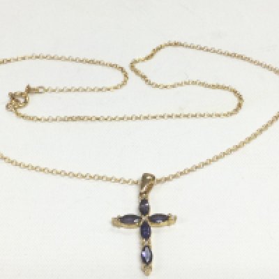 A 9ct gold cross pendant on chain set with blue stones, approx 4g. Shipping category A.