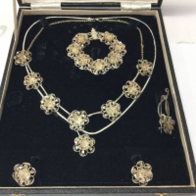 A silver filigree jewellery set including necklace earrings brooch and bracelet. Postage B