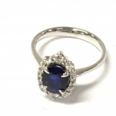 A 14ct white gold ring set with an oval sapphire and halo of graduated diamonds. Sapphire 1ct approx and diamonds 0.40ct Size M 1/2. Postage B