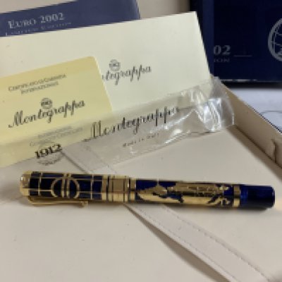 A 2002 euro Montegrappa 18k gold and blue enamel roller ball Ben with box and papers. The map of Europe accent around the pen is also hallmarked 18k gold. Limited 80/100