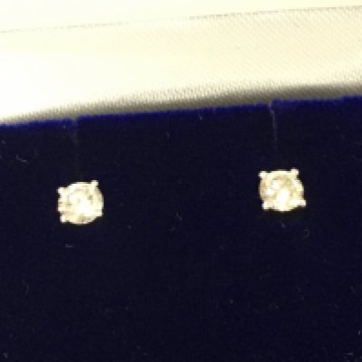 A pair of platinum solitaire diamond studs Diamonds approx 0.38ct total. Postage B