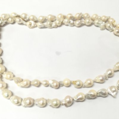An extra long and weighty string of organic shaped baroque pearls. Approximately 50 inches long so can be worn a single or wrapped round to give the illusion of double strand.
