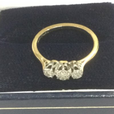 An 18ct gold and platinum three stone diamond ring, approx 2.6g and approx size L-M. Shipping category A.