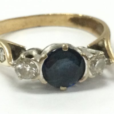 A sapphire stone 9ct ring set with two diamonds, 4g total weight. Postage category A