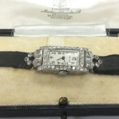 A 1930s Longines ladies cocktail watch, recently serviced. The watch is set with square and round old cut diamonds, approx 1.5ct in total, and with a platinum case. Shipping category A.