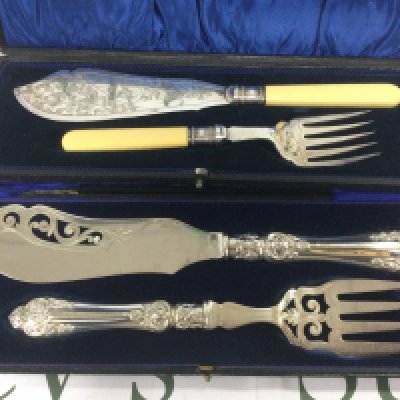 A cased silver fish slice and server set together with a silver plated set. Shipping category B.