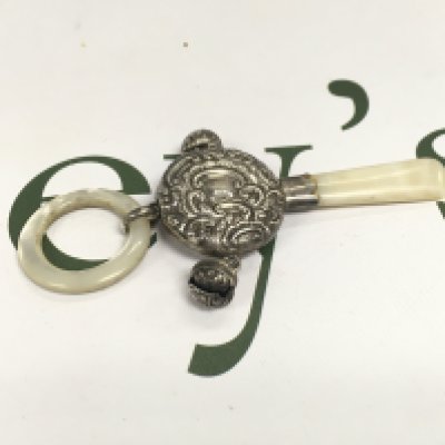 A silver childs rattle.