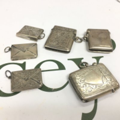 Three silver vesta cases and three silver stamp cases.
