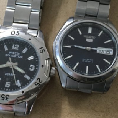 A collection of cufflinks a silver pendant on chain and two watches.