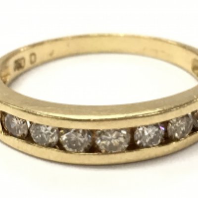 An 18ct gold Channel set diamond 1/2 hoop ring. 3.2g total weight. N/O. Postage category A