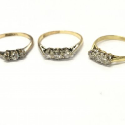 An 18ct three stone diamond ring, sizes K/L, N, L. 5.6g total weight Postage category A