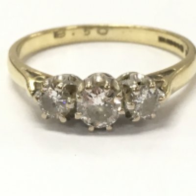 An 18ct gold three stone diamond ring, 2.4g total weight, size N. Postage category A