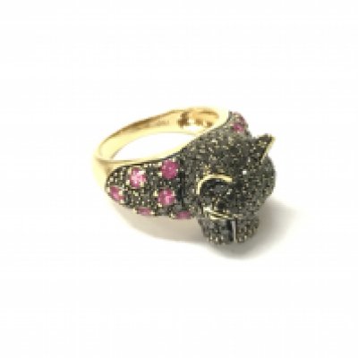 A stone set panther head ring stamped 750 set with black diamonds and rubies, Approx weight 6.99 grams. Size L 1/2.
