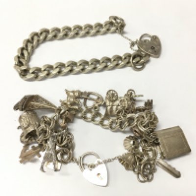 A silver charm bracelet and a silver curb bracelet it&#2013266057۪s a heart lock clasp. Approx weight 79.83 grams.