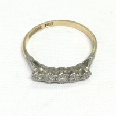 An 18ct gold and platinum ring set with five small diamonds, approx 2.6g and approx size S-T. Shipping category A.