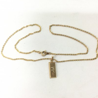 A 14k gold pendant on a chain (not gold). Pendant approx 1.2g. Shipping category A.