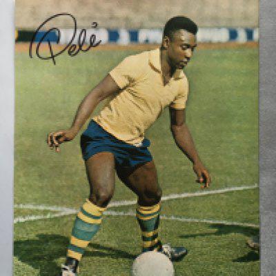Pele Signed Brazil Football Picture: Large colour magazine picture of a young Pele hand signed in marker pen. C/W and unsigned picture of him with Bobby Moore.