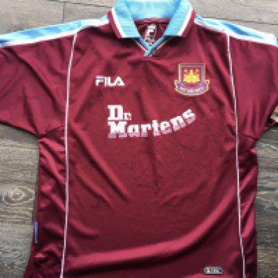 West Ham Signed Football Shirt: BNWT home Dr Martens shirt lightly signed by 13 including Lampard and Moncur. C/W some England + West Ham related t-shirts. (10)