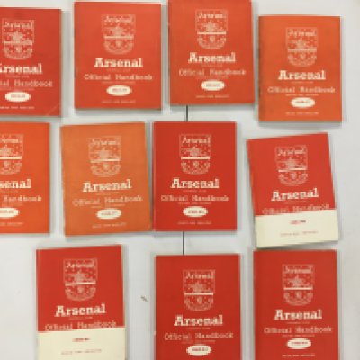 Arsenal Football Memorabilia Box: 11 handbooks with 6 from the 50s and 5 from the 60s. Quantity of overall fair condition 50s and 60s home programmes. Nice scrapbook from 68/69 which has a few programmes and tickets stuck in along with cuttings and privately taken photos.