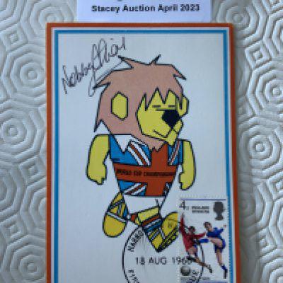 Nobby Stiles Signed 1966 World Cup Willie Postcard: Original unwritten postcard with FA 1966 to rear and stamped Cameo Stamps Ltd. WC Willie has first day of issue England Winners stamp 18 8 1966 and is hand signed by Stiles.