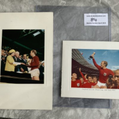 1966 England World Cup Winners Official Christmas Cards: Both FIFA and the English FA used Christmas cards depicting Bobby Moore with the World Cup. FIFA opted for Bobby shaking hands with the Queen after receiving the World Cup and the FA went for Bobby being held aloft with team mates whilst holding the cup. Both unwritten with Christmas wishes printed and dated December 1966. Rare and in very good condition. FIFAs card has been signed by president Stanley Rous and secretary Helmet Kaser which we believe are printed autographs. (2)