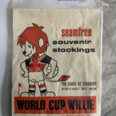 1966 World Cup Willie Stockings + Knitting Patterns: Pair of stockings in original packaging featuring WC Willie advertising the seam free souvenir stockings, made by the House of Tudsbury. C/W knitting patterns one to make a WC Willie blazer badge, the other to make a car cushion and WC Willie doll. Nice items. (3)