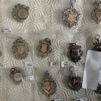 Football Memorabilia Box: Includes complete set of Joe Mercers Cleveland Busts with stand, 1968 club colours poster supplement with Jag, Books, Esso 1970s coin set and badge set plus an Everton rosette.