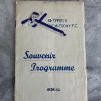 1929/1930 Sheffield Wednesday v Arsenal Football Programme: Special edition with blue and white ribbons to commemorate winning the Football League the previous season. 16 page programme has souvenir cover and is good with no writing. Rusty staples holding firm.