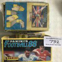 Panini Football 88 Unopened Box Of Football Stickers: Complete box of 100 packs and an opened box without lid containing a further 6 packs. Unopened box still has plastic wrapping but has creasing.