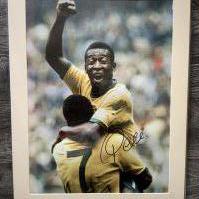Pele Signed Brazil Football Print: In mount measuring 27 x 20 inches with COA from leading dealer A1 Sporting Memorabilia. Depicts Pele celebrating goal.