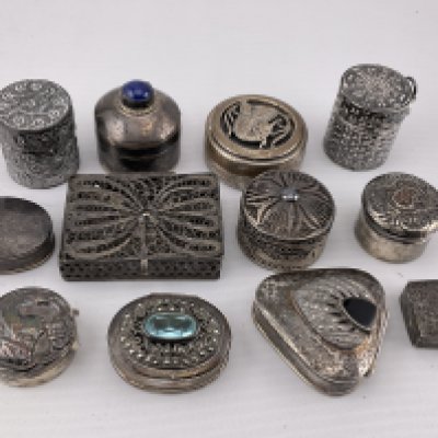 A collection of silver and white metal pill boxes. Postage category A.