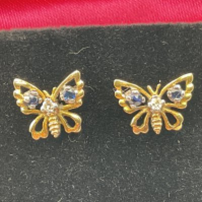A pair of 9ct yellow gold butterfly earrings set with sapphires and diamond. Postage category A.