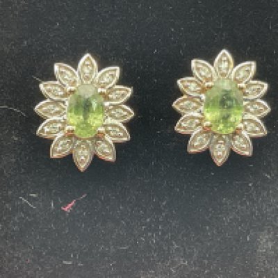 A pair of 9ct gold earrings set with citrine. Postage category A.