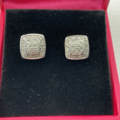 A pair of 9ct white gold diamond earrings. Postage category A.